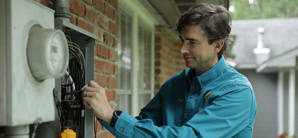 Electrician working with an electrical panel