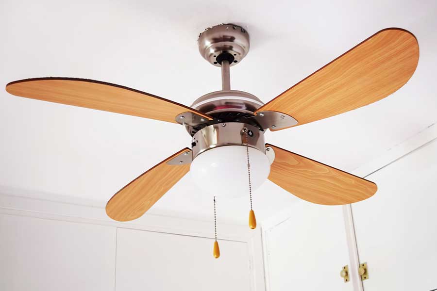 Professional ceiling fan installation underway